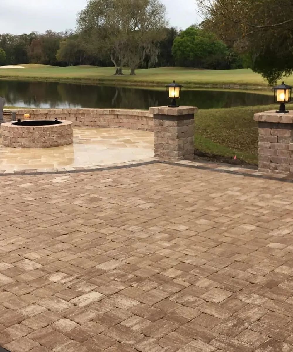 A patio with brick walls and fire pits.