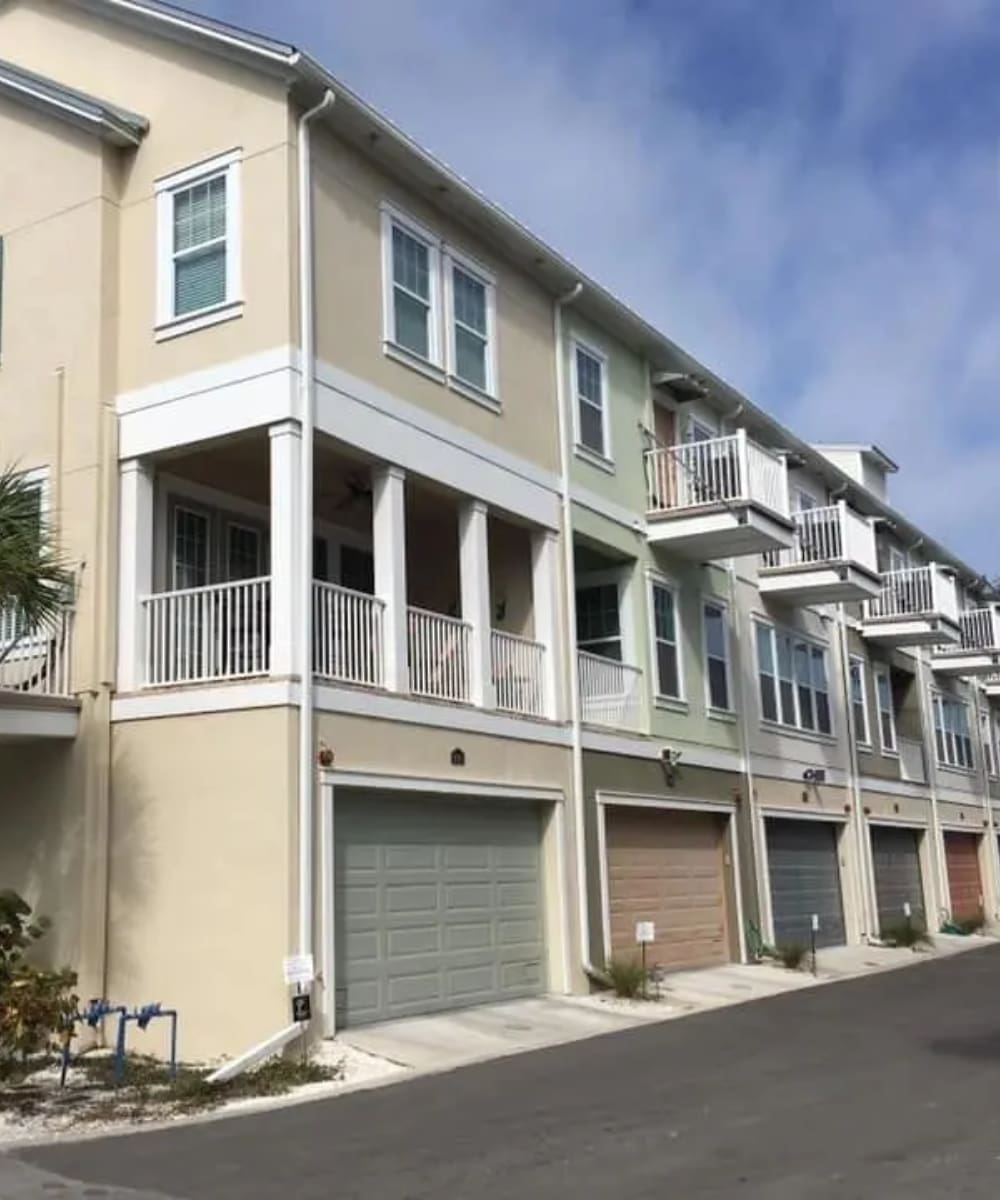 A row of houses with garage doors on the side.