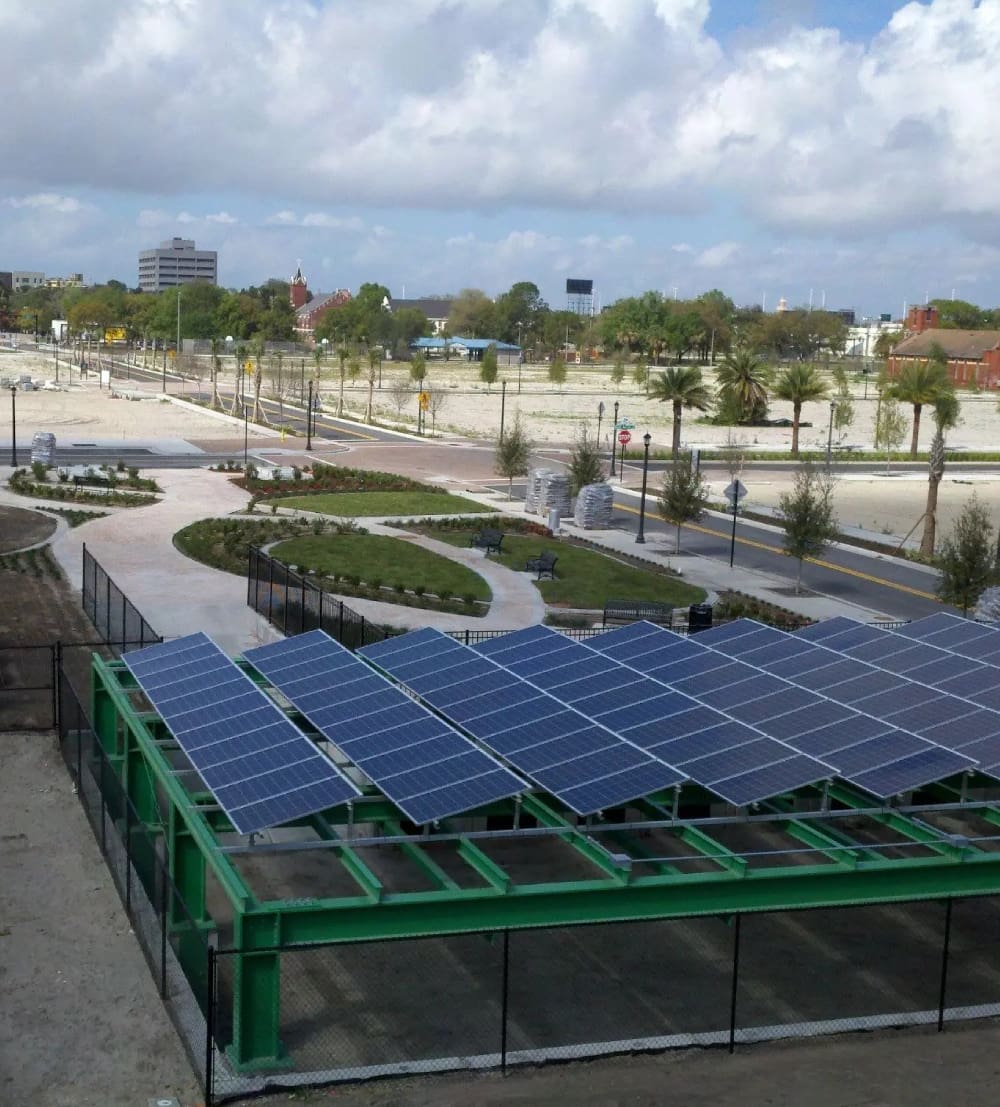 A large green structure with solar panels on top of it.